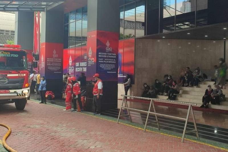 Sejumlah karyawan di Gedung Kemenkumham berhamburan keluar usai dievakuasi petugas damkar, Kamis (8/12/2022).