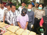 Suyono (mengenakan topeng hitam) saat mengikuti pemusnahan ganja di halaman kantor kelurahan Jombang